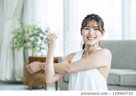 Young woman training at home Young woman training at home 139994730