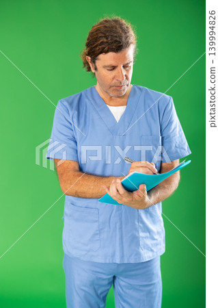 nurse makes notes in a document against the background of chromakey nurse makes notes in a document against the background of chromakey 139994826