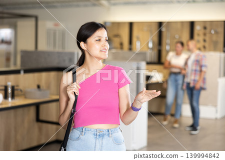 Young woman looking around in bathroom department Young woman looking around in bathroom department 139994842
