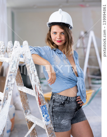 Tempting woman in revealing attire posing in construction site 139994861