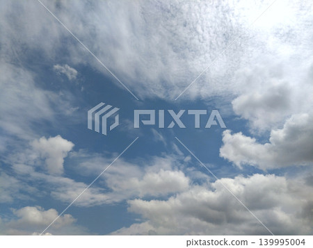 A landscape of white clouds and delicate cloud patterns spreading across a blue sky. A landscape of white clouds and delicate cloud patterns spreading across a blue sky. 139995004