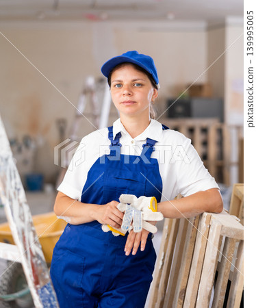 Portrait of positive woman builder during repair works Portrait of positive woman builder during repair works 139995005
