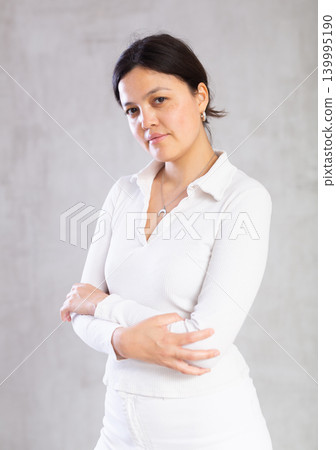Portrait of young woman in casual clothes posing in studio 139995190