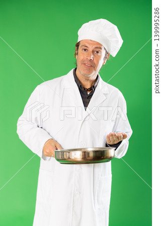 Man cook with frying pan address appeal to imaginary interlocutor, explain technology. Man cook with frying pan address appeal to imaginary interlocutor, explain technology. 139995286