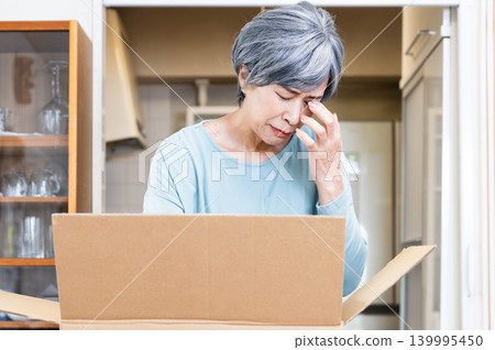 一位老婦人在整理她的物品 139995450