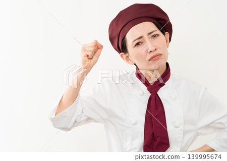 A woman wearing a baker's uniform 139995674
