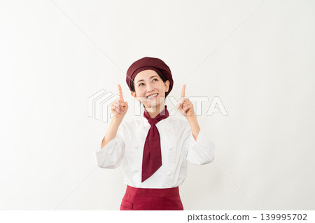 A woman wearing a baker's uniform A woman wearing a baker's uniform 139995702