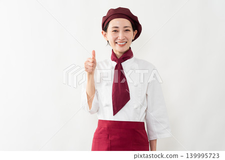 A woman wearing a baker's uniform A woman wearing a baker's uniform 139995723