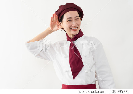 A woman wearing a baker's uniform A woman wearing a baker's uniform 139995773