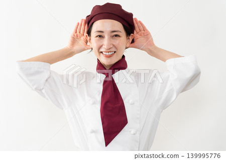 A woman wearing a baker's uniform A woman wearing a baker's uniform 139995776