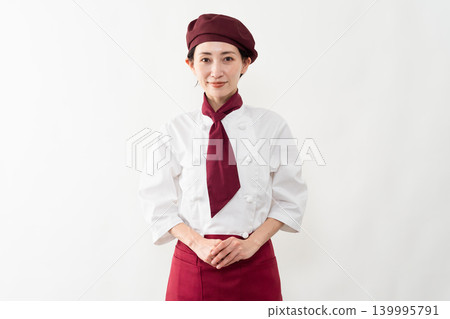 A woman wearing a baker's uniform A woman wearing a baker's uniform 139995791