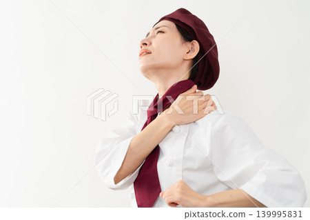 A woman wearing a baker's uniform A woman wearing a baker's uniform 139995831