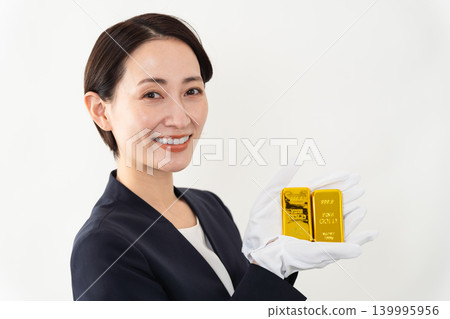 A woman in a business suit holding an ingot - Brand image A woman in a business suit holding an ingot - Brand image 139995956