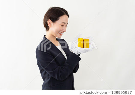 A woman in a business suit holding an ingot - Brand image A woman in a business suit holding an ingot - Brand image 139995957