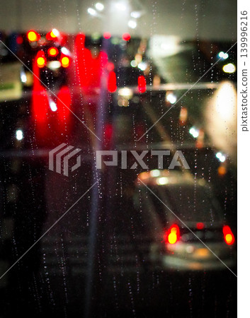 雨滴落在窗上,城市夜景盡收眼底。 雨滴落在窗上,城市夜景盡收眼底。 139996216