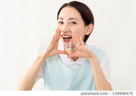一位身穿淺藍色圍裙的女士;護理人員的形象。 一位身穿淺藍色圍裙的女士;護理人員的形象。 139996470