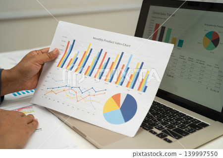 Asian business woman working with financial graph. 139997550