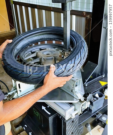 installing motorcycle tires with an automatic machine installing motorcycle tires with an automatic machine 139997957