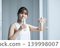 Young woman drinking water 139998007