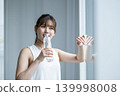 Young woman drinking water 139998008