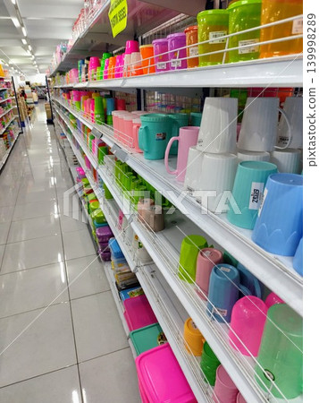 Kitchen utensils such as glasses, bowls and plastic plates are neatly arranged on shelves sold in stores Kitchen utensils such as glasses, bowls and plastic plates are neatly arranged on shelves sold in stores 139998289