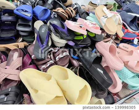 pile of sandals for sale in the shop 139998305