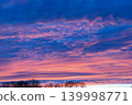 Beautiful blue hour sky with pink and purple sunset clouds over trees 139998771