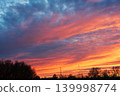 Colorful fiery sunset sky with dramatic clouds over rural landscape 139998774
