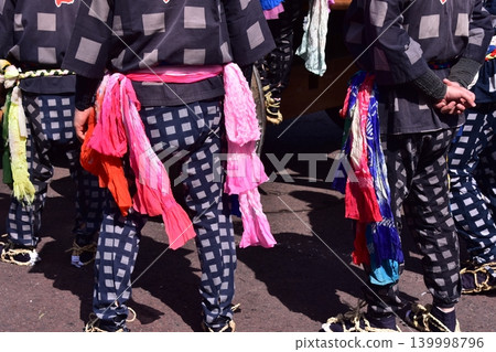 Men participating in the Inuyama Spring Festival in Inuyama City, Aichi Prefecture, are seen wearing traditional happi coats, straw sandals, and brightly colored obi belts. 139998796