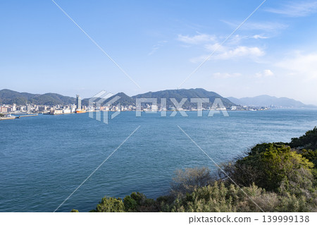A seaside view overlooking Mojiko Port and Shimonoseki city under a clear blue sky. A seaside view overlooking Mojiko Port and Shimonoseki city under a clear blue sky. 139999138