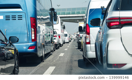 Dense City Traffic With Cars And Bus On Busy Highway, Urban Transportation Congestion And Daily Commuting Concept Dense City Traffic With Cars And Bus On Busy Highway, Urban Transportation Congestion And Daily Commuting Concept 139999146