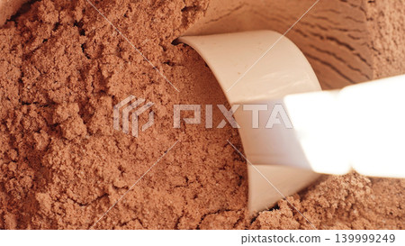 Close Up Measured Chocolate Whey Protein Powder In Scoop, Sports Nutrition And Supplement Texture Concept Close Up Measured Chocolate Whey Protein Powder In Scoop, Sports Nutrition And Supplement Texture Concept 139999249