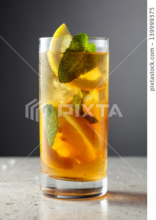 Iced tea in a misted glass on a stone table. 139999375
