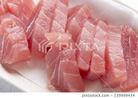 Fresh tuna sashimi served on a white plate - a Japanese dish. Fresh tuna sashimi served on a white plate - a Japanese dish. 139999434