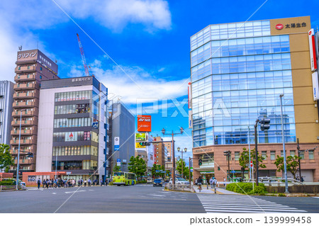Yokohama cityscape, Japan, May 28th, in front of the north exit of Kannai Station. View of the "Hagoromo-cho" intersection and commuters in the morning. 139999458