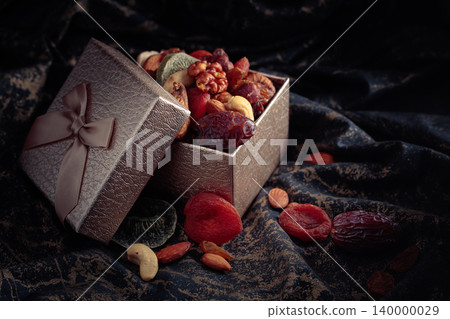 Dried tropical fruits, nuts, and raisins in gift box. 140000029