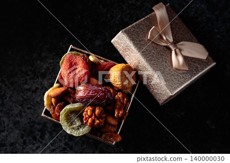 Dried tropical fruits, nuts, and raisins in gift box. Dried tropical fruits, nuts, and raisins in gift box. 140000030