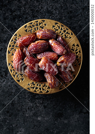 Dates fruits on black stone table. Dates fruits on black stone table. 140000032