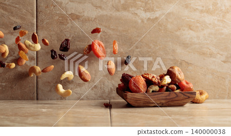 Mix of dried fruits and nuts in motion. Mix of dried fruits and nuts in motion. 140000038