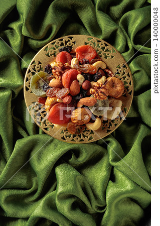 Assortment of dried tropical fruits, nuts and raisins. 140000048