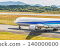 Close-up of a large passenger plane heading towards the runway 140000600
