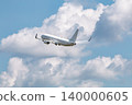 A passenger plane, a blue sky, and clouds. 140000605