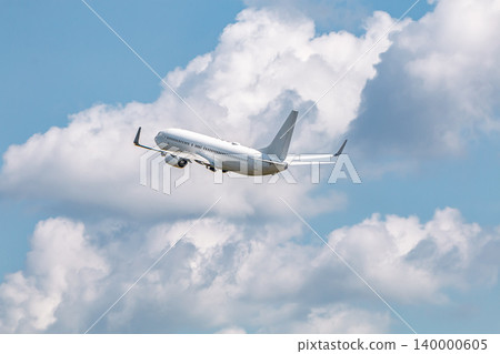 A passenger plane, a blue sky, and clouds. A passenger plane, a blue sky, and clouds. 140000605