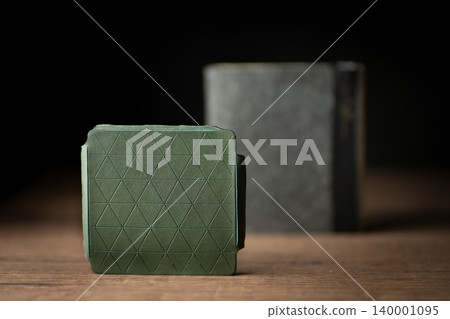 Handmade green wallet made of genuine leather on a wooden background. Close-up, top view. Handmade green wallet made of genuine leather on a wooden background. Close-up, top view. 140001095