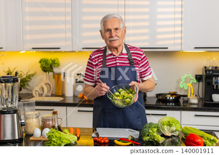 Senior old man teaching vegetable salad recipe in kitchen at home for healthy diet cooking tutorial Senior old man teaching vegetable salad recipe in kitchen at home for healthy diet cooking tutorial 140001911