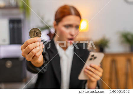 Young businesswoman sees crypto crash on smartphone sighs over investment loss and very disappointed Young businesswoman sees crypto crash on smartphone sighs over investment loss and very disappointed 140001962