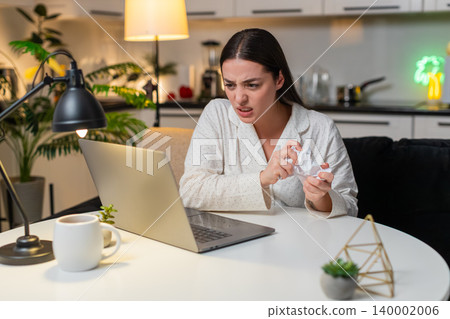 Young woman angry at utility bill crumples receipt throws papers worries about big charges evening Young woman angry at utility bill crumples receipt throws papers worries about big charges evening 140002006