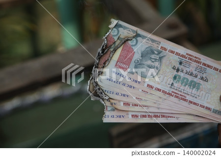 Burning Indian Currency closeup Burning Indian Currency closeup 140002024