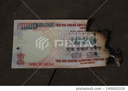 Burning Indian Currency closeup Burning Indian Currency closeup 140002026