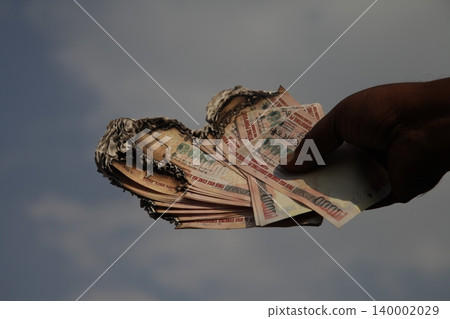 Burning Indian Currency closeup Burning Indian Currency closeup 140002029